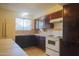 Efficient kitchen with white stove and wood cabinets at 5720 E Cicero St, Mesa, AZ 85205