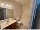 Clean bathroom with single vanity, bathtub, and shower at 5829 E Nora St, Mesa, AZ 85215