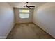 Bright bedroom with a ceiling fan and window coverings at 5829 E Nora St, Mesa, AZ 85215