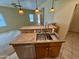 Kitchen island with granite countertop and double sink at 5829 E Nora St, Mesa, AZ 85215