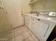 Bright laundry room with washer, dryer, and tile floor at 5829 E Nora St, Mesa, AZ 85215