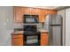 Well-equipped kitchen featuring granite counters and wood cabinets at 5877 N Granite Reef Rd # 1160, Scottsdale, AZ 85250