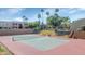 Community tennis court with a net and red and green surface at 5877 N Granite Reef Rd # 1160, Scottsdale, AZ 85250