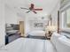 Bright bedroom featuring two queen beds, a ceiling fan, and large windows at 6000 E Camelback Rd # 7707, Scottsdale, AZ 85251