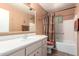 Bathroom featuring a shower-tub combo and single sink vanity with a medicine cabinet at 6058 E El Paso St, Mesa, AZ 85205