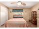 Comfortable bedroom with a ceiling fan, closet and natural lighting at 6058 E El Paso St, Mesa, AZ 85205