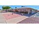 Community building with shaded seating areas and well-maintained grounds at 6058 E El Paso St, Mesa, AZ 85205