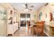 Bright dining area with sliding glass doors to a screened patio, and adjacent shelving at 6058 E El Paso St, Mesa, AZ 85205