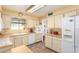 Well-lit kitchen with tile flooring, classic appliances, and plenty of cabinet space at 6058 E El Paso St, Mesa, AZ 85205