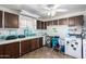 Bright laundry room with tile floors, cabinets, and a modern washer and dryer at 6058 E El Paso St, Mesa, AZ 85205