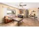 Living room featuring tile flooring, neutral walls, comfortable seating, and a window overlooking the backyard at 6058 E El Paso St, Mesa, AZ 85205