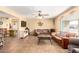 Cozy living room with tiled floor, ceiling fan, leather sofa, and view of adjoining spaces at 6058 E El Paso St, Mesa, AZ 85205