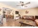 Open-concept living room with tile flooring, ceiling fan, view of dining area, and comfortable seating at 6058 E El Paso St, Mesa, AZ 85205