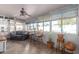 Cozy sun room with tile floor, large windows, ceiling fan, and comfortable seating arrangement at 6058 E El Paso St, Mesa, AZ 85205