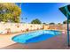 Beautiful backyard pool area complete with decorative wall art and lush landscaping at 6058 E El Paso St, Mesa, AZ 85205