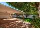 Covered patio with brick flooring, offering shade and access to the backyard at 7663 E Coolidge St, Scottsdale, AZ 85251