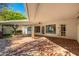 Large covered patio with brick pavers and access to the house at 7663 E Coolidge St, Scottsdale, AZ 85251