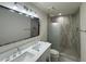 Updated bathroom with double vanity, modern lighting, and a walk-in shower at 7663 E Coolidge St, Scottsdale, AZ 85251