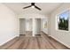 Spacious bedroom with mirrored closet doors and wood-look floors at 7663 E Coolidge St, Scottsdale, AZ 85251