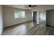 Bright bedroom with hardwood floors, mirrored closet doors, and a ceiling fan at 7663 E Coolidge St, Scottsdale, AZ 85251