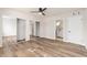 Bedroom with mirrored closet doors and wood-look floors at 7663 E Coolidge St, Scottsdale, AZ 85251