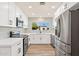 Modern white kitchen with stainless steel appliances at 7663 E Coolidge St, Scottsdale, AZ 85251