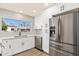 Updated kitchen featuring white cabinets and a large window at 7663 E Coolidge St, Scottsdale, AZ 85251