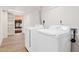 Laundry room with washer, dryer, and built-in shelving at 7663 E Coolidge St, Scottsdale, AZ 85251