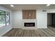 Bright living room featuring hardwood floors and a modern electric fireplace at 7663 E Coolidge St, Scottsdale, AZ 85251