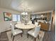 Bright dining room with round table, white chairs, and view into the kitchen, creating an inviting and open space at 8103 E Southern Ave # 84, Mesa, AZ 85209