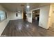 Living room with grey laminate flooring and view into kitchen at 8103 E Southern Ave # 84, Mesa, AZ 85209