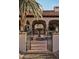 Inviting courtyard entrance with a decorative fountain, lush plants, and an arched entryway at 8119 E Foothills Dr, Scottsdale, AZ 85255