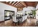 Bright dining room with beam ceiling, chandelier, tile floors, and open layout at 8119 E Foothills Dr, Scottsdale, AZ 85255