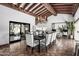 Open dining room with beamed ceilings, unique tile floor, and view of outdoor landscaping at 8119 E Foothills Dr, Scottsdale, AZ 85255