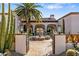 Elegant front entrance with a charming fountain, lush greenery, and a welcoming open gate at 8119 E Foothills Dr, Scottsdale, AZ 85255