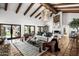 Elegant living room featuring exposed beams, a stone fireplace, and stylish decor at 8119 E Foothills Dr, Scottsdale, AZ 85255