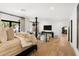 Spacious main bedroom featuring light wood floors, white walls, and a sitting area at 8119 E Foothills Dr, Scottsdale, AZ 85255