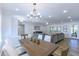 Bright dining room with wood table and white chairs, features a chandelier and hardwood floors at 814 S 78Th St, Mesa, AZ 85208