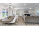 Modern dining area with a wood table and white chairs, adjacent to the living room at 814 S 78Th St, Mesa, AZ 85208