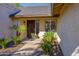 Front entry with a decorative iron door and nicely landscaped walkway at 814 S 78Th St, Mesa, AZ 85208