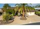 Desert landscaping with a large palm tree and cacti accents the front of this single-level home at 814 S 78Th St, Mesa, AZ 85208