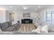 Living room with gray sectional and electric fireplace, hardwood floors at 814 S 78Th St, Mesa, AZ 85208