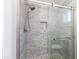 Modern shower with pebble tile accents and glass enclosure at 814 S 78Th St, Mesa, AZ 85208