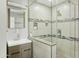 Modern bathroom showcasing a glass shower, updated vanity, and decorative tile accents at 8312 E Mackenzie Dr, Scottsdale, AZ 85251