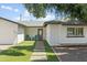 Attractive home featuring artificial turf and a brick pathway leading to the front door at 8312 E Mackenzie Dr, Scottsdale, AZ 85251