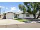 Inviting curb appeal with a well-maintained lawn and a cozy two-car garage at 8312 E Mackenzie Dr, Scottsdale, AZ 85251