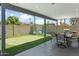 Outdoor entertainment area with a putting green, covered patio, and dining set at 8312 E Mackenzie Dr, Scottsdale, AZ 85251