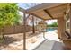 Relaxing backyard with pergola, providing shade over patio area at 8773 W Pineveta Dr, Arizona City, AZ 85123