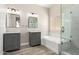 Modern bathroom with double sinks, soaking tub, and walk-in shower at 8773 W Pineveta Dr, Arizona City, AZ 85123