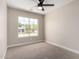 Well-lit bedroom with window, ceiling fan, and carpet at 8773 W Pineveta Dr, Arizona City, AZ 85123